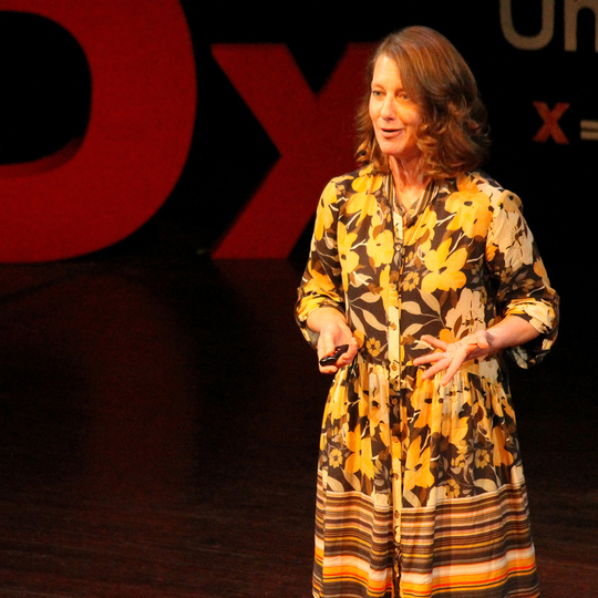 Carolyn presenting on stage for TED.